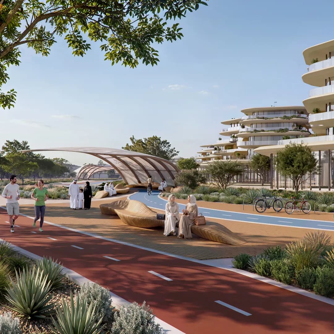 Waterfront promenade with a running track, cycle lane and shaded seating beside residential buildings